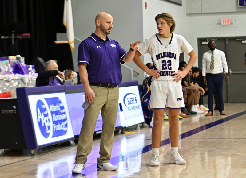 Royals head coach Pat Woods reviews a play with junior guard Joshua LoRusso.