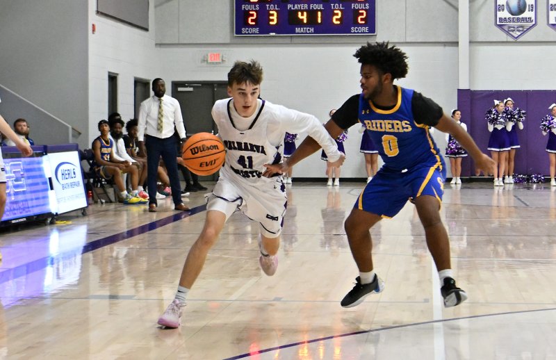 Royals sophomore guard Asher Woods drives past Caesar Rodney’s Jaxon Timmons.