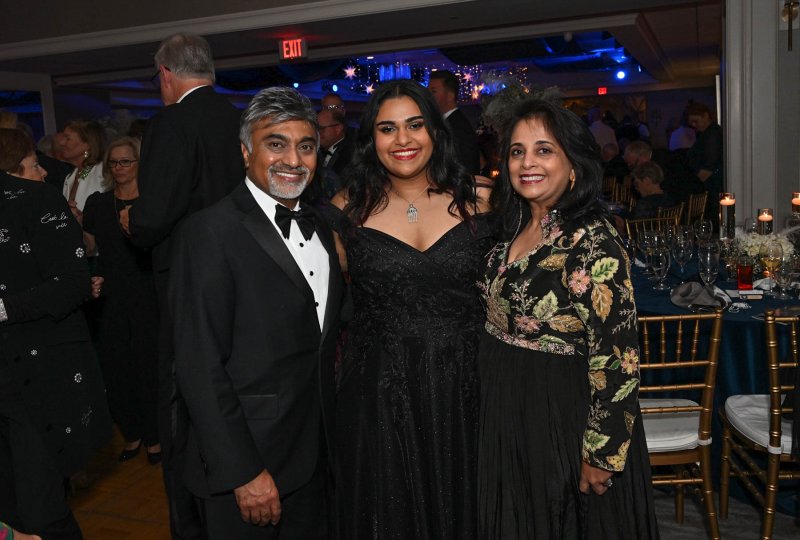 Harry Keswani stands for a photo with his daughter Angie, center, and wife Sonia.