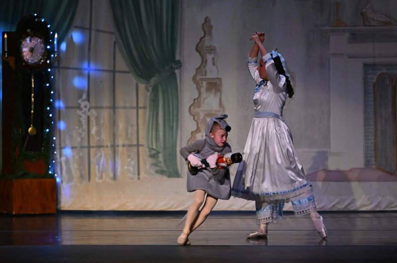 Vivian Oswald as lead mouse steals the nutcracker doll from Clara.