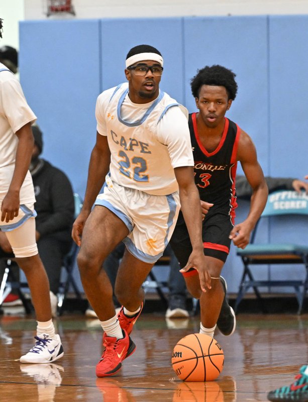 Oz Batson speeds the ball up court on a fast break.