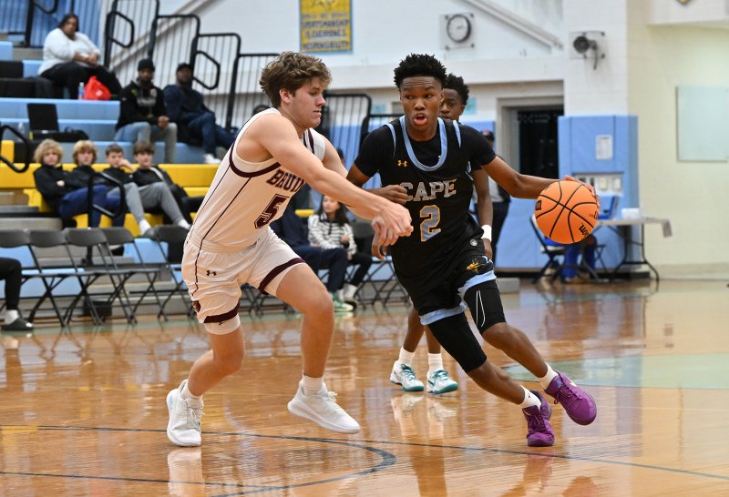 Cape’s Geordan Downing drives past Broadneck’s Drew Cahall during last year’s Beach Slam tournament. DAN COOK PHOTO