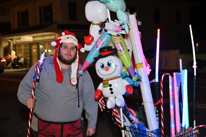 Noah Strouse sells light toys at the parade.