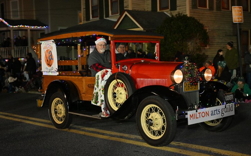 Members of the Milton Arts Guild drive in their antique car.