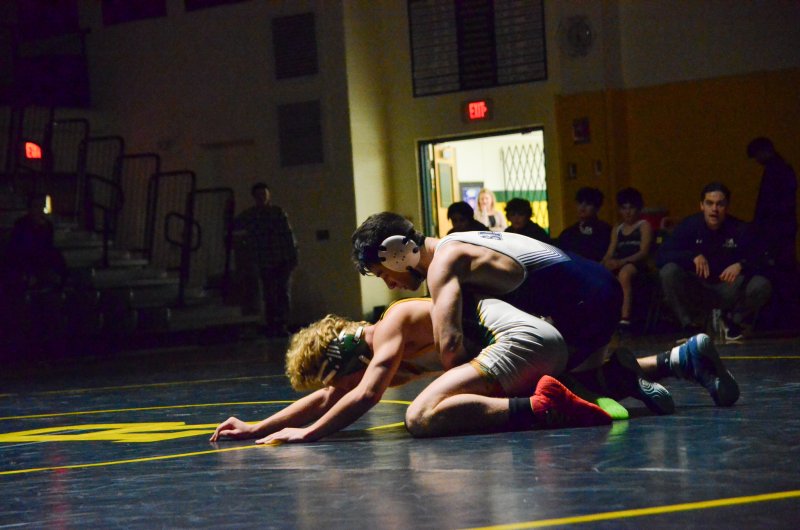 Sussex Academy senior Ryan Buckler tries to keep Blake Whittington down.