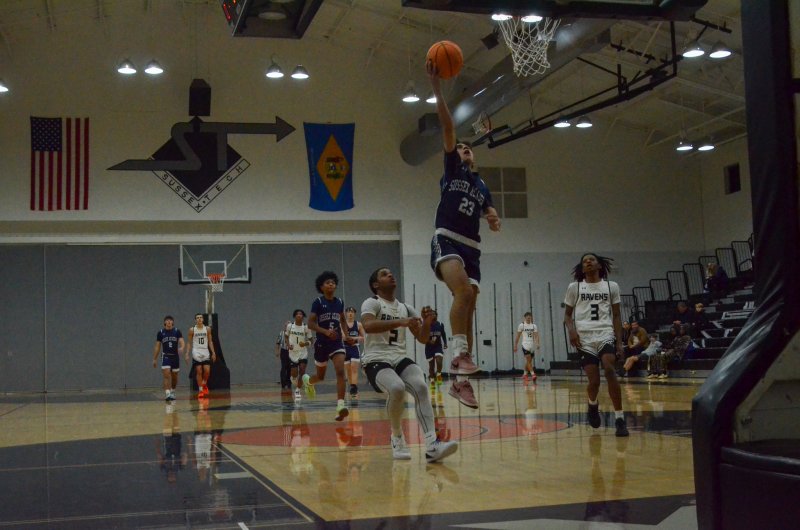 Sussex Academy junior Ryan Dostal finishes at the rim following his steal.