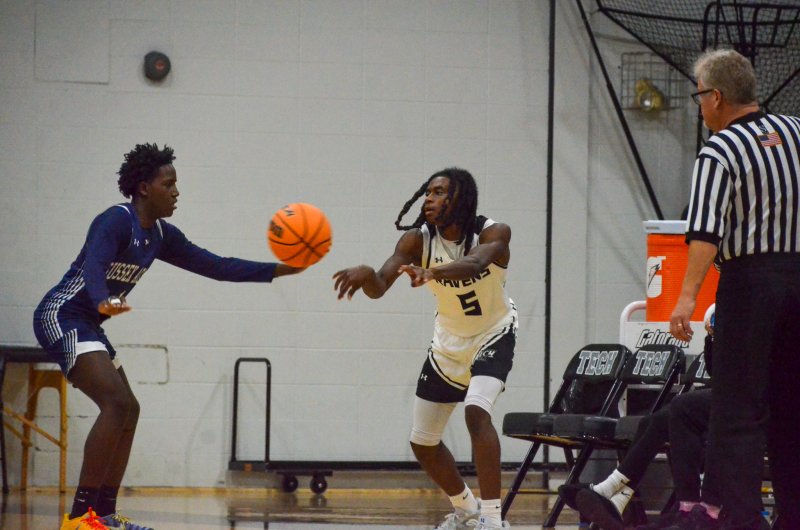 As Sussex Academy sophomore Farmar Amisial presses out, Sussex Tech junior Kahmari Hopkins passes.