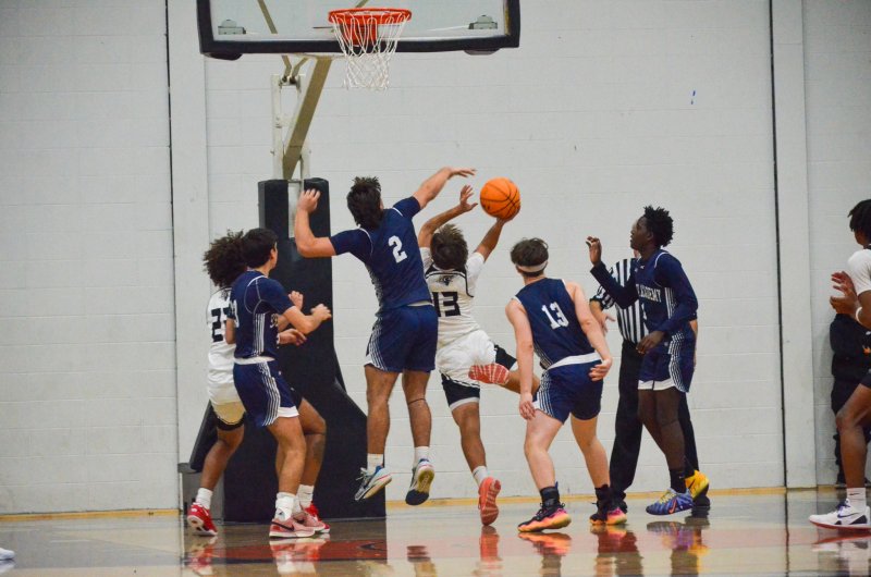 Seahawks sophomore Mason Glover tries to get a block on Ravens senior Kenton James.