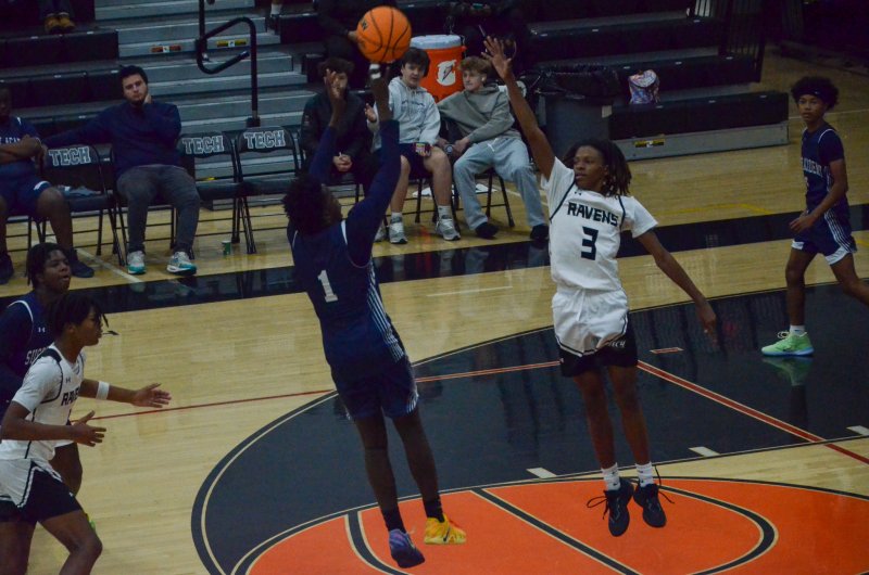 Sussex Academy freshman Jarrett Hinmon tries to get a hand up on Farmar Amisial’s shot.