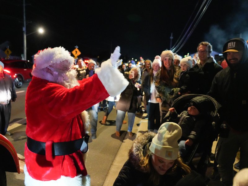 Santa Claus waves to an awaiting crowd at the Fifer’s Christmas tree lighting in Dewey Beach Nov. 29.