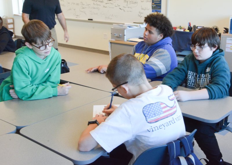 Fred Thomas Middle School sixth-graders working together in a financial education lesson on spending or saving money are (l-r) Roman Veet, Carter Cohen, Jordan Haynes and Cooper Skocypec.