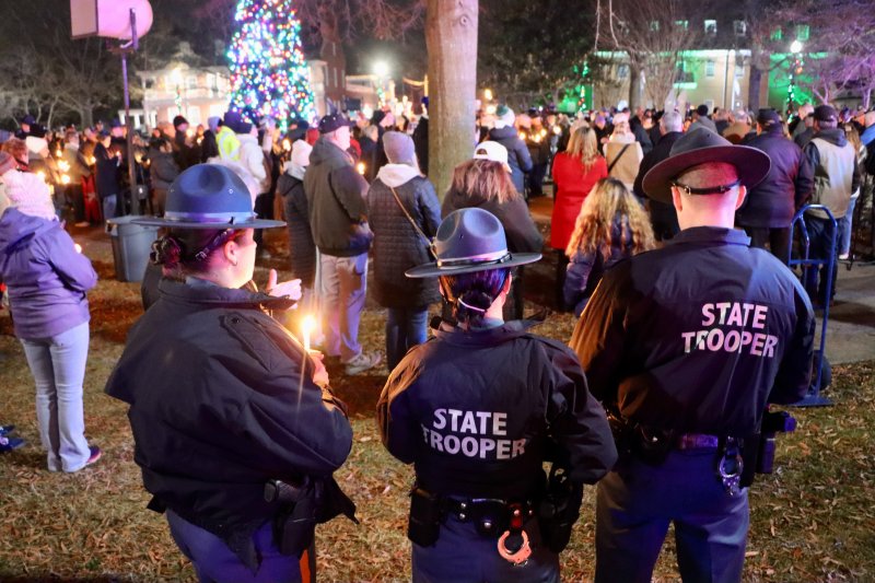 Delaware state troopers are among the law enforcement officers from around the state participating in the candlelight ceremony on the Circle.