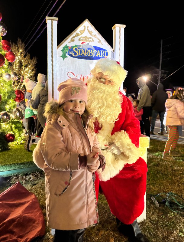Ainsley Skarda meets Santa Claus at the Fifer’s Farm Kitchen tree lighting in Dewey Beach Nov. 29.