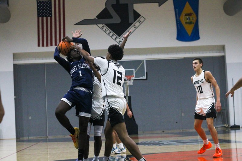 Sussex Academy sophomore Farmar Amisial tries to get a shot above Sussex Tech junior Omari Weatherspoon in the Seahawks’ season-opening 64-43 loss to the Ravens Dec. 4. Amisial scored 20 points in the game. AARON R. MUSHRUSH PHOTOS