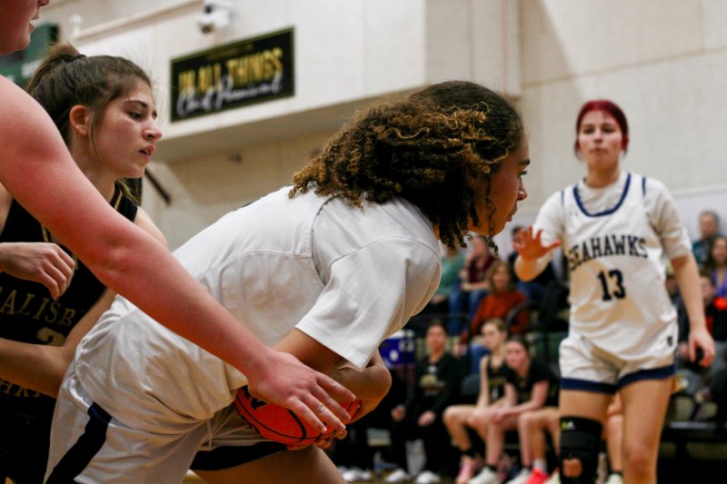Sussex Academy junior Bella Zorn offers help to freshman Barb Carneiro-Duarte before a tie-up.
