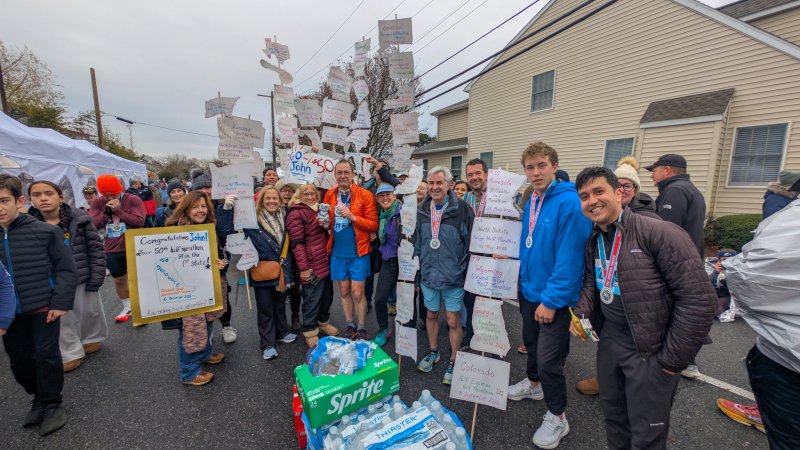 John Newsam was the center of attention for friends, families and fellow runners after completing his goal.
