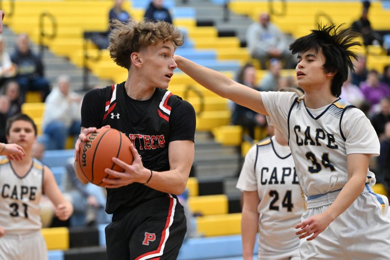Cape’s Ronald LeRoy plays defense on Polytech’s Deacon Herring.