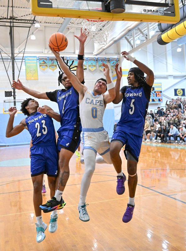 Cape’s Lamar McCoy goes strong to the hoop in overtime.