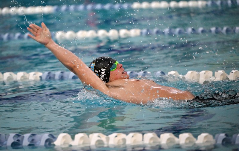 Senior Ryan Morgan wins the 100 backstroke.