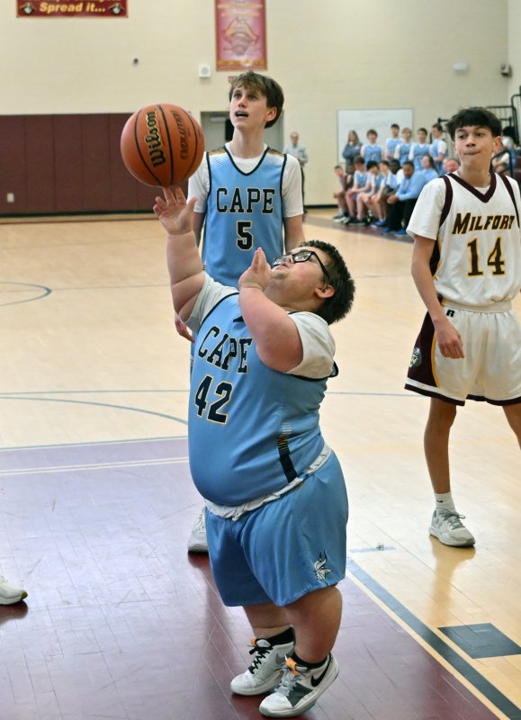 Cape sophomore Norman Rust hits underneath. He scored two points in the game.