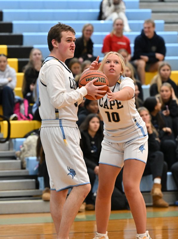 Cape junior Elizabeth Sprague, right, assists on a shot by teammate Daniel Gartman.