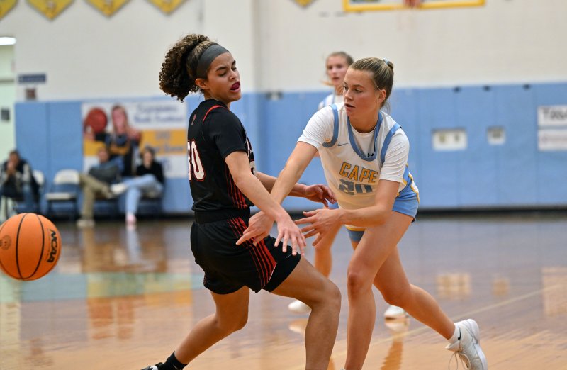 Ally Diehl passes to the paint around Polytech’s Sierra Henry.