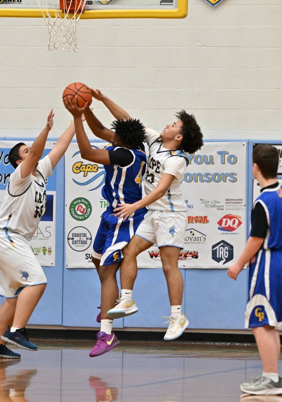 Cape freshman Darren Fraiman, right, and teammate Austin Hastings get a block on Caesar Rodney’s Noah Wenteler-Bunch.