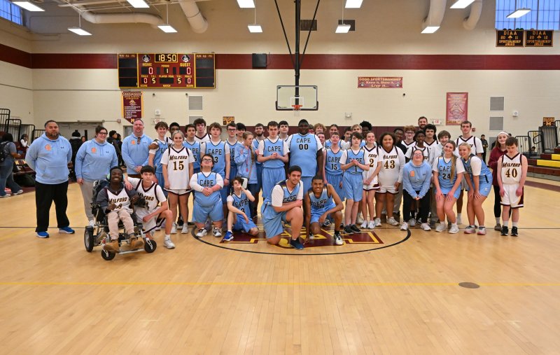The Cape and Milford teams get together to celebrate their game and their friendship. DAN COOK PHOTOS