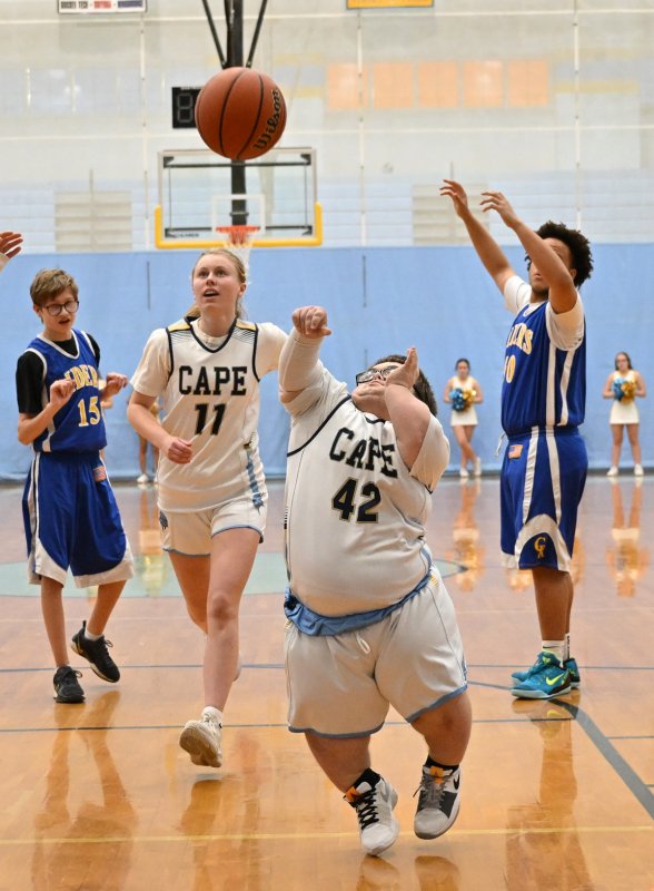 Cape’s Norman Rust takes a shot in the paint as teammate Grace Heers crashes the boards.