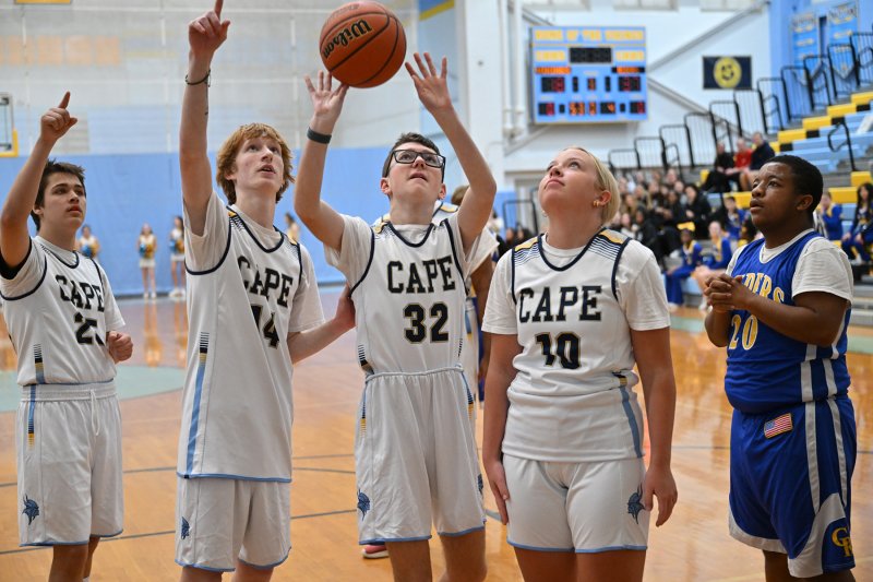 Cape freshman Cullen Oliver takes a shot while his teammates look to get the boards.