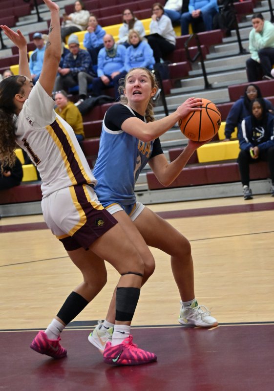 Cape junior Mairead Rishko looks to go up strong on Milford’s Tristen Showell.