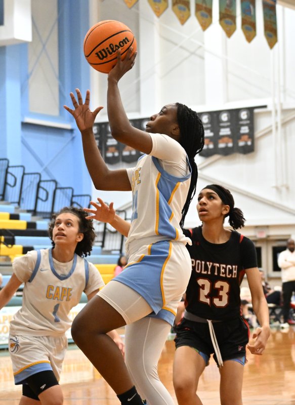 Senior Jurnee White goes up for a deuce.