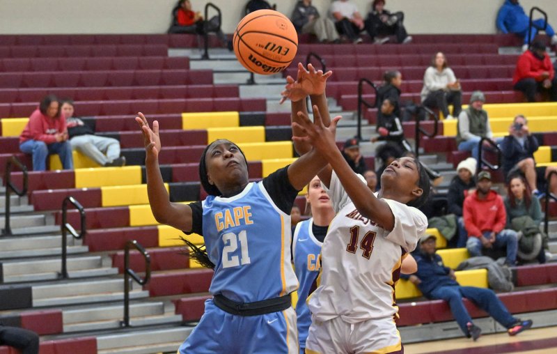 Cape senior Jurnee White, left, battles for a rebound with Milford’s London White in the win over the Bucs. DAN COOK PHOTOS