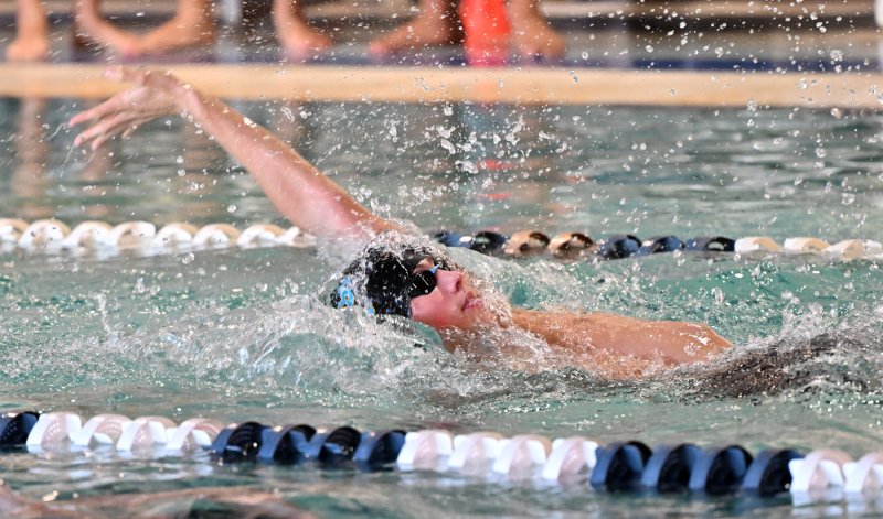 Freshman William Passo swims the backstroke.