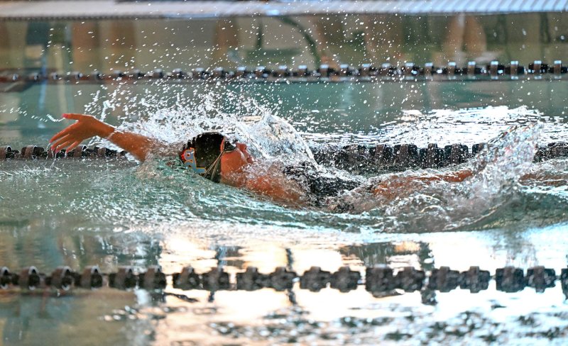 Senior Sidney Caldwell swims the backstroke leg of the winning medley relay team. DAN COOK PHOTOS