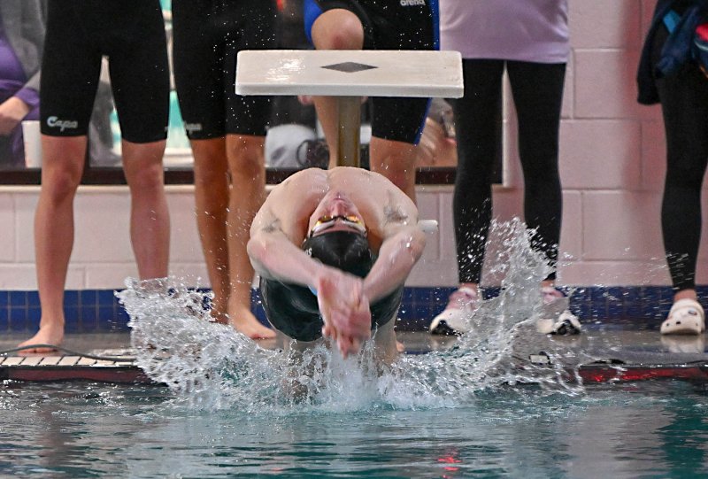 Cape junior Brady Schell swims the backstroke leg of the winning 200 medley relay.