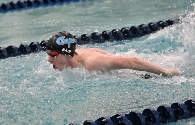 John Bain wins the 100 fly with a 1:04.62.