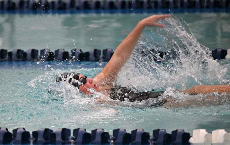 Cape senior Sidney Caldwell swims the backstroke leg on the winning medley relay.