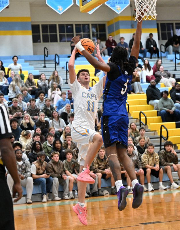 Senior Braxton Figgs goes in strong to the hole.
