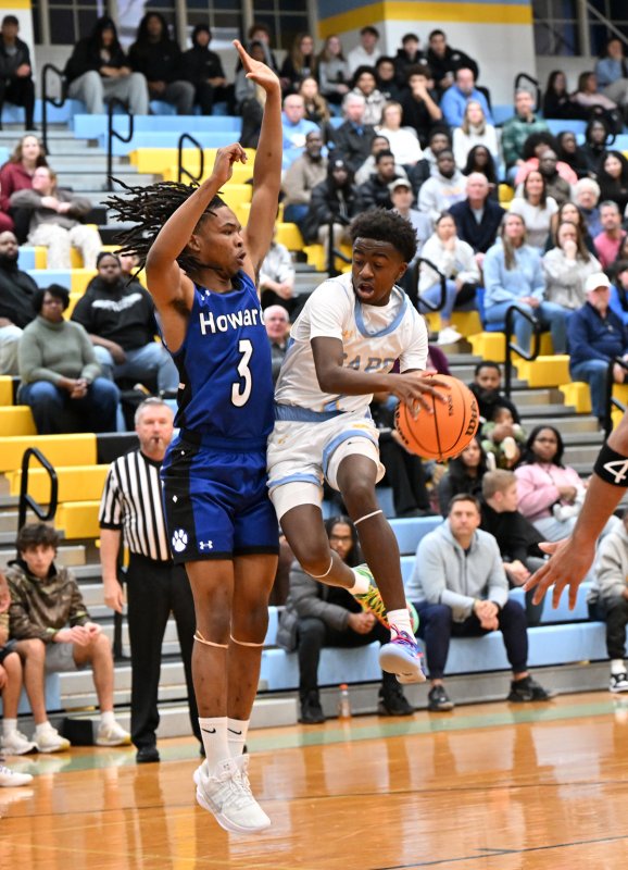 Junior point guard Stephen Sivels glides into the paint on Howard’s Jah'Cere Campbell-Reynolds.