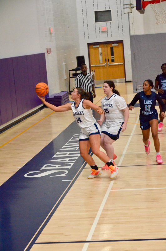 Seahawks senior Eva Boos watches Grayce Glover save the ball. The girls are teammates on the softball diamond as well as the hardwood.
