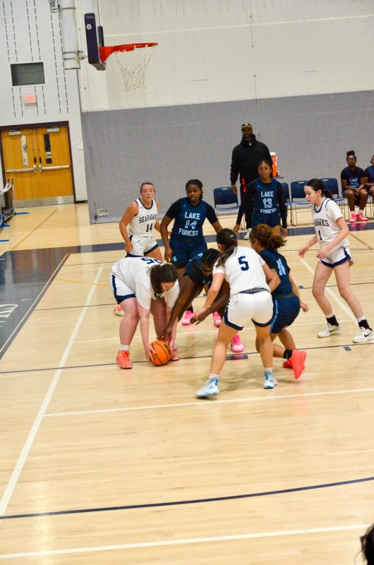 Sussex Academy senior Eva Boos scoops up a loose ball.