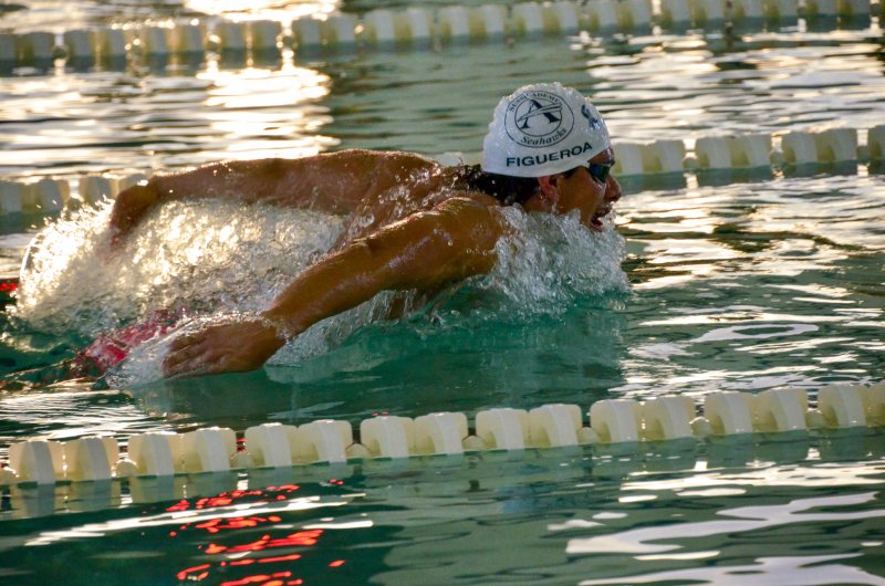 Sussex Academy senior Angel Figueroa splashes forward in the butterfly.