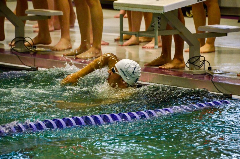 Seahawks senior Christian Wright looks at the times to see that he just swam the fastest 100 freestyle leg in program history during the 400 freestyle relay.
