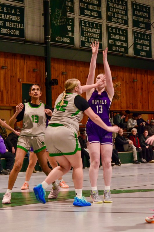 Delmarva Christian freshman Hannah Silben connects despite a hand in her face.