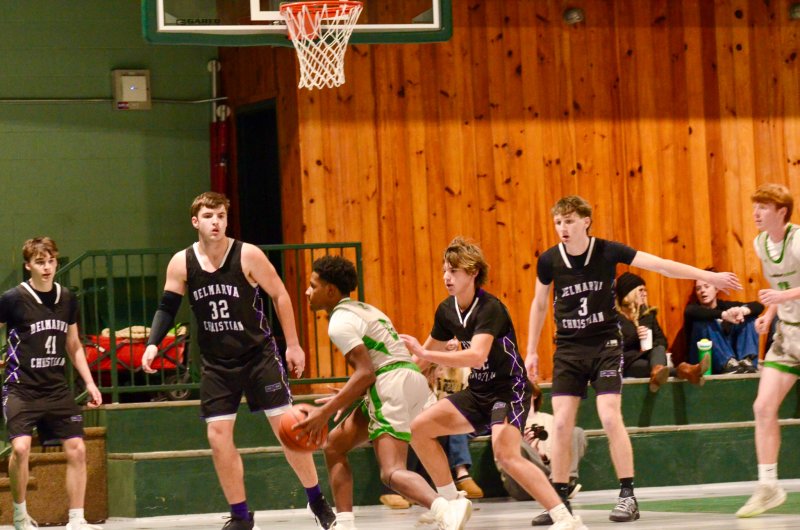 Royals junior Josh LoRusso plays defense in the half court with (l-r) Asher Woods, Andrew Collins and Noah Barbrow behind him.