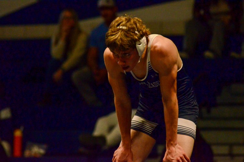 Sussex Academy junior Jeremy VanPelt grabs some air late in his match.
