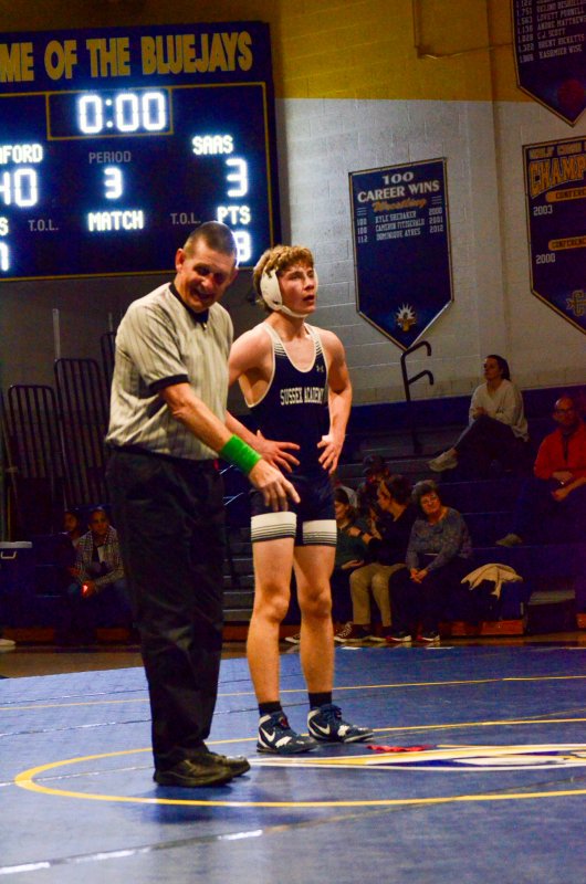 Sussex Academy junior Jeremy VanPelt waits to shake hands after an 8-7 win.
