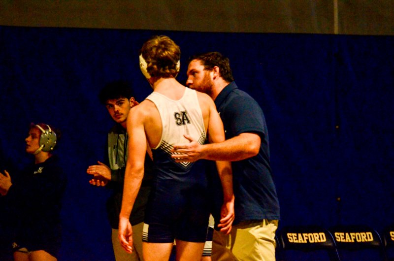 Sussex Academy coach Billy Ott congratulates Jeremy VanPelt after the junior held on for an 8-7 victory in the Seahawks’ 76-3 loss to Seaford Jan. 28. AARON R. MUSHRUSH PHOTOS