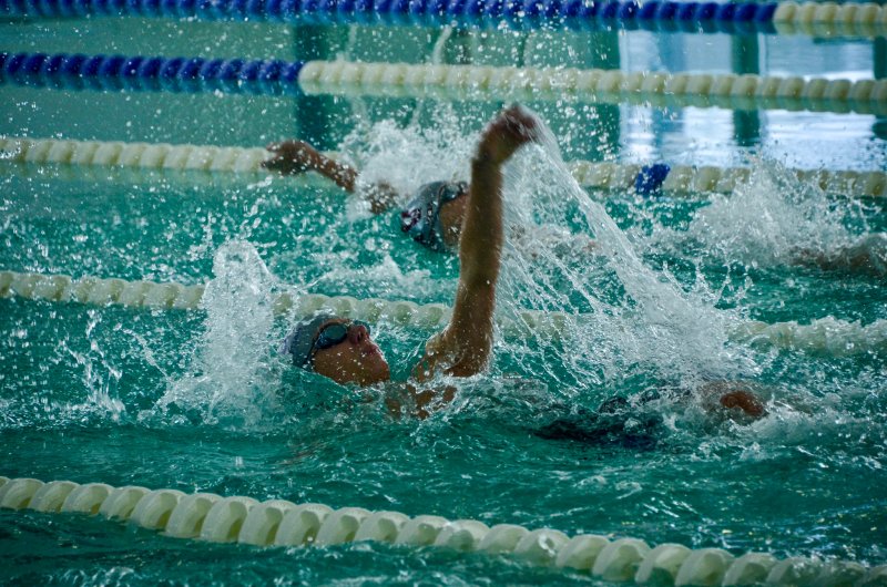 Royals sophomore Jack Louden swims the backstroke during the medley relay.